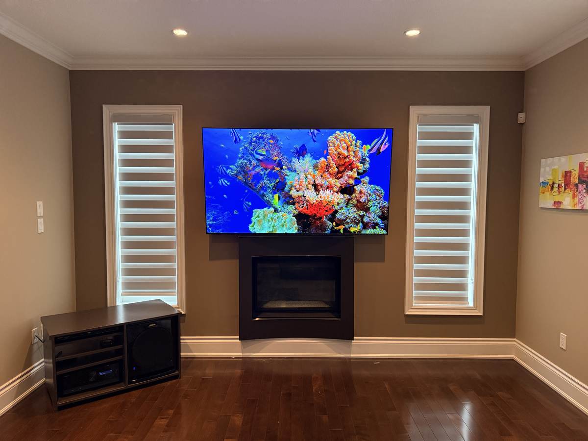 Above a fireplace, between two windows