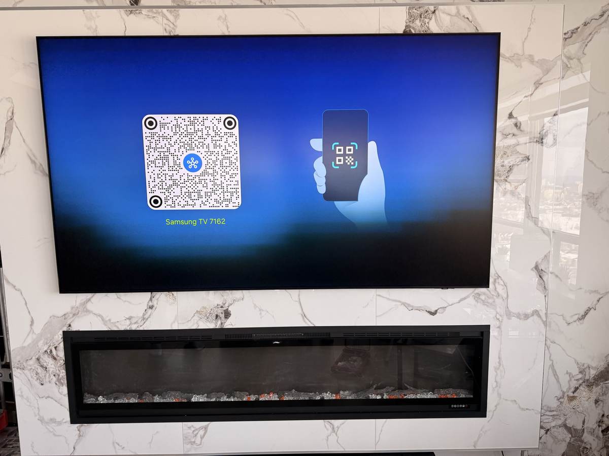 Above an electric fireplace on a marble feature wall