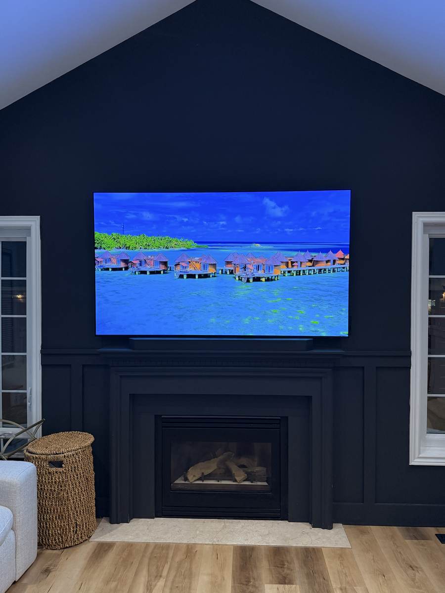 TV and soundbar above a painted fireplace